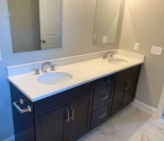 A bathroom with two sinks and mirrors.