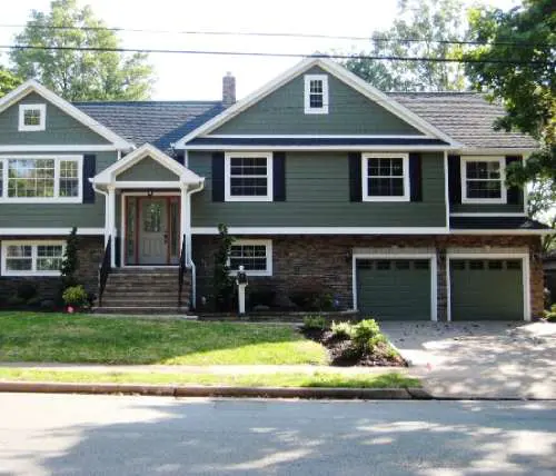 A house with green siding and white trim.