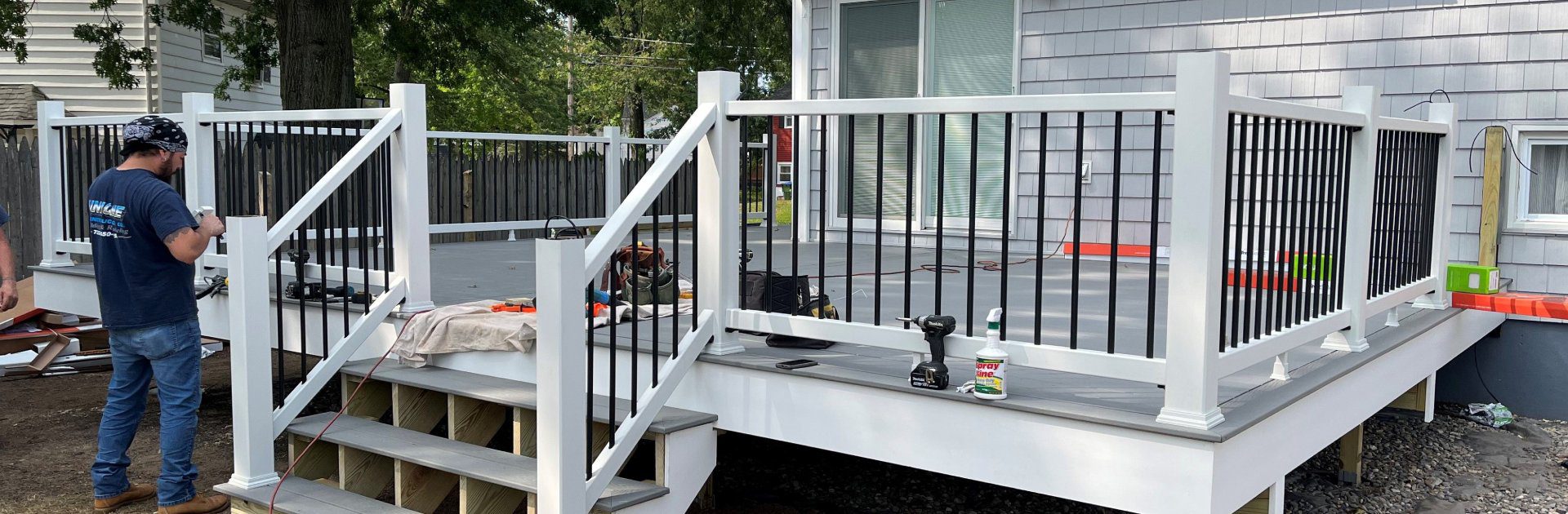 A person is sitting on the porch of their home.