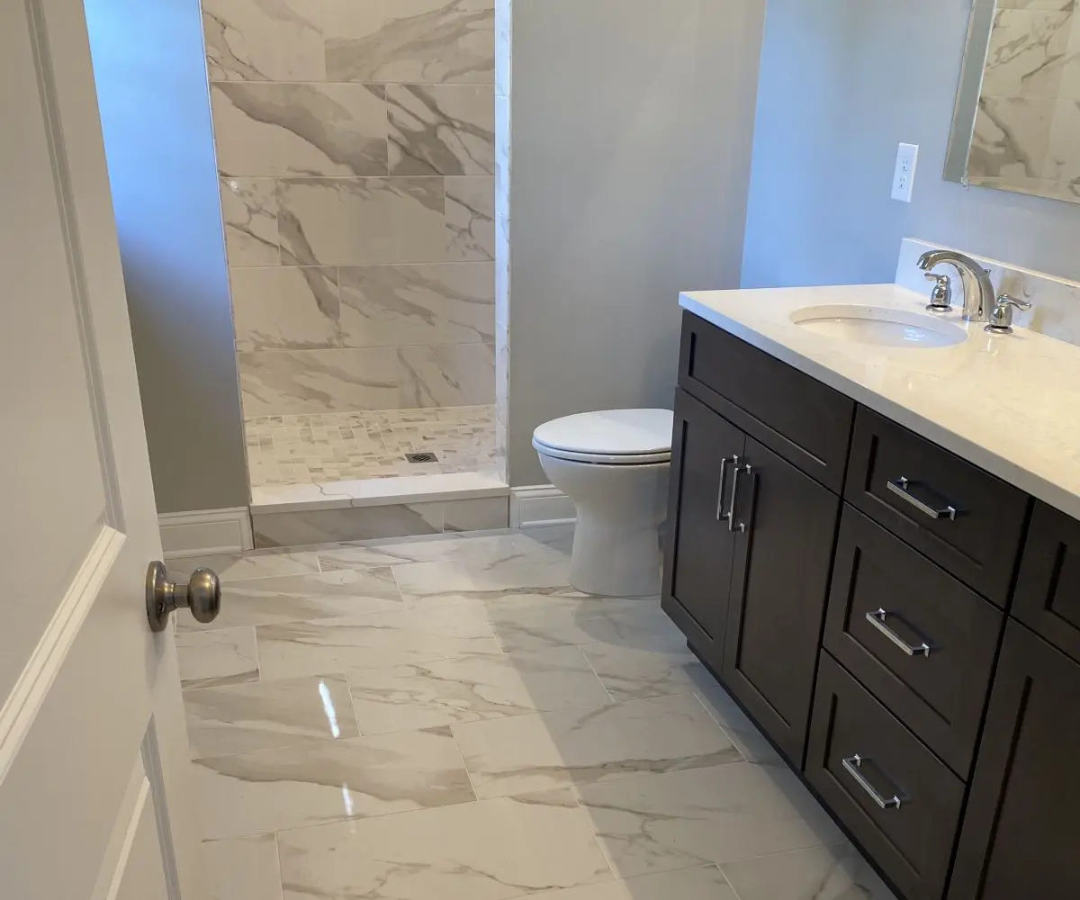 A bathroom with marble floors and walls.