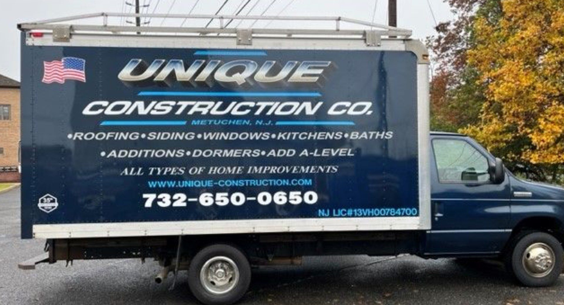 A truck with the words unique construction company on it.